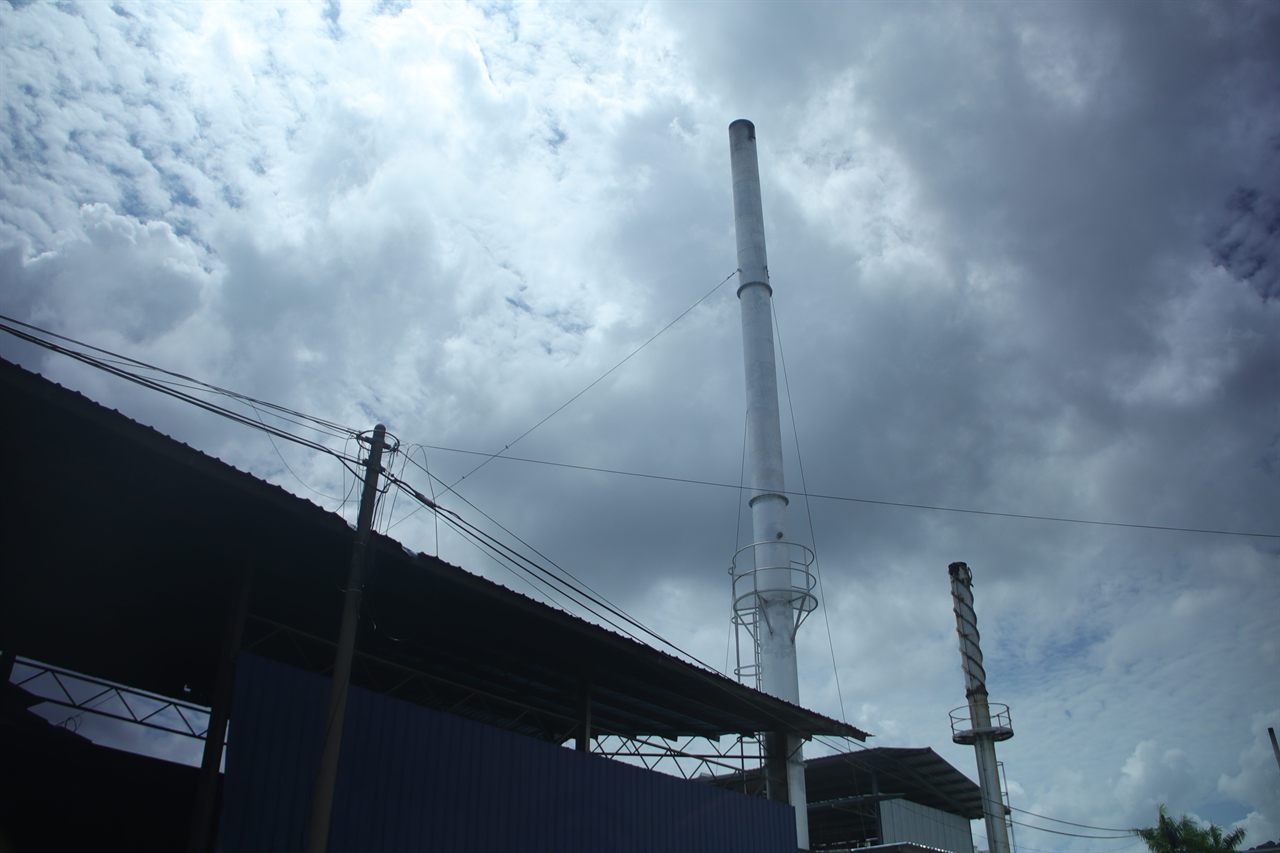 Hupsin dyeing factory exterior — boiler stack against the sky