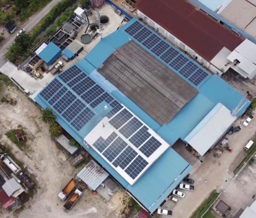 Aerial view of Hupsin Dyeing factory — rooftop solar array across the production halls, Batu Pahat