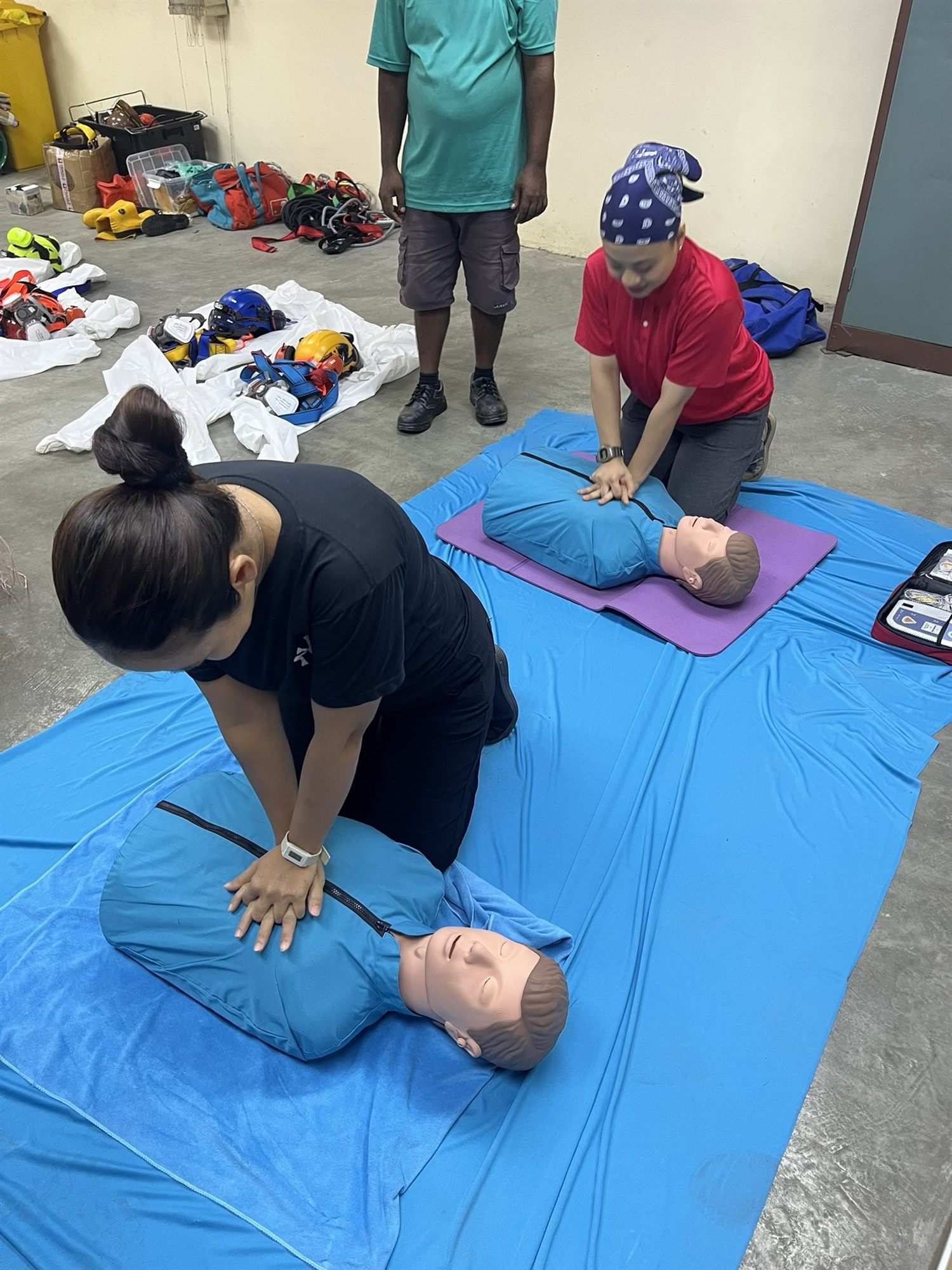 Staff practicing CPR on training mannequins