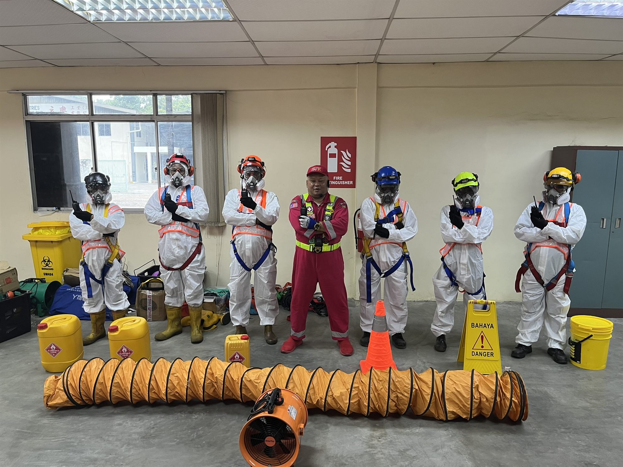 Hupsin Emergency Response Team — full chemical-suit gear with ventilation duct and safety equipment