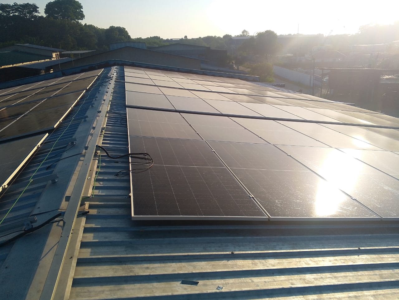 Rooftop solar array at sunset — Hupsin Dyeing factory, Batu Pahat